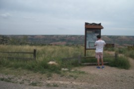 Micah looking at sign at Palo Duro Canyon State Park near Amarillo