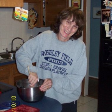 Me wearing a hand me down sweatshirt from the 2003 trip Do not let the date on this picture deceive you. It was taken at Christmas 2011. Not sure what I am cooking in this picture maybe chocolate chip cookies.